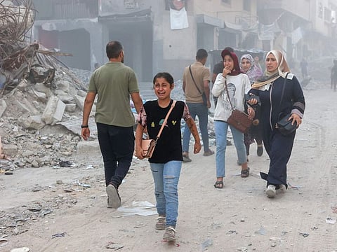 A Palestinian girl cries following Israeli bombardment which hit a school complex, including the Hamama and Al Huda schools, in the Sheikh Radwan neighbourhood in the north of Gaza City on August 3, 2024.