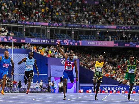 Winner US' Noah Lyles (centre) crosses the finish line ahead of Italy's Lamont Marcell Jacobs, Botswana's Letsile Tebogo, Jamaica's Oblique Seville and South Africa's Akani Simbine in the men's 100m final of the athletics event at the Paris 2024 Olympic Games at Stade de France in Saint-Denis, north of Paris, on Sunday.