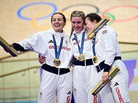 Britain's Katy Marchant, Britain's Sophie Capewell and Britain's Emma Finucane celebrate their gold medal on the podium during the medals ceremony after winning the women's track cycling team sprint final of the Paris 2024 Olympic Games at the Saint-Quentin-en-Yvelines National Velodrome in Montigny-le-Bretonneux, south-west of Paris, on Monday.
