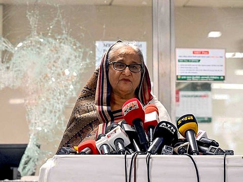 In this handout photograph taken and released on July 25, 2024 by Bangladesh Prime Minister's Office, Prime Minister Sheikh Hasina addresses the media at a vandalized metro station in Mirpur, after the anti-quota protests.