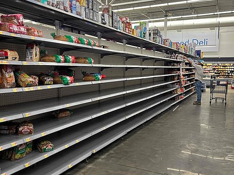 A bread aisle is almost bare in a Walmart store as people stock up before the possible arrival of Tropical Storm Debby in Florida.