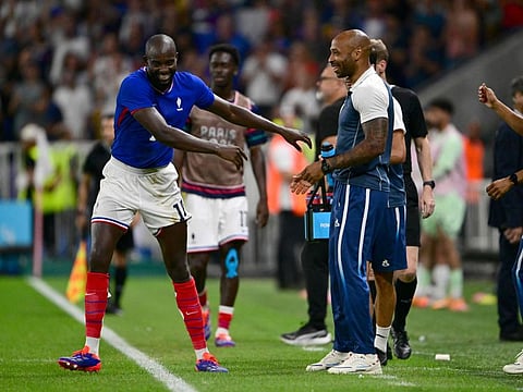 France's forward Jean-Philippe Mateta celebrates scoring his team's second goal with coach Thierry Henry during the men's semi-final football match against Egypt during the Paris 2024 Olympic Games at the Lyon Stadium in Lyon on Monday.