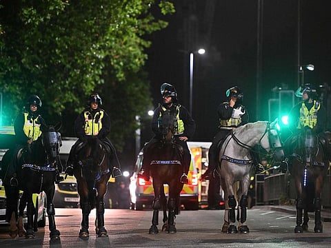 Mounted riot police stand on duty outside a hotel housing asylum seekers to protect the premises from the 'Enough is Enough' demonstration called by far-right activists in Bristol.