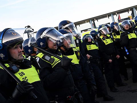 Police officers stand guard during a 'Enough is Enough' demonstration called by far-right activists in Weymouth, on the southwest coast of England where the Bibby Stockholm migrant accommodation barge is moored.