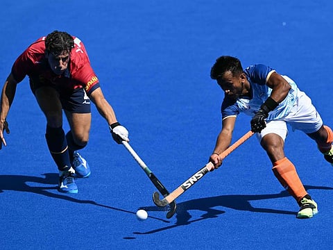 Spain's midfielder Joaquin Menini fights for the ball with India's midfielder Vivek Sagar Prasad in the men's bronze medal field hockey match during the Paris 2024 Olympic Games at the Yves-du-Manoir Stadium in Colombes on Thursday.