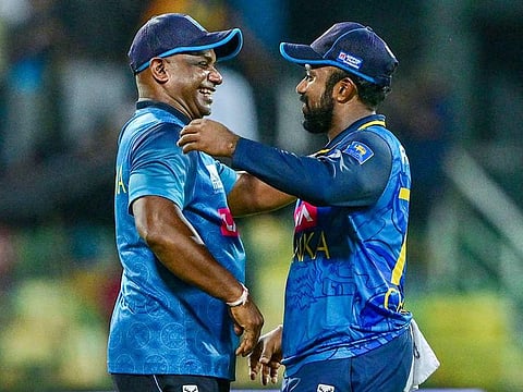 Sri Lanka's interim coach Sanath Jayasuriya (left) and captain Charith Asalanka celebrate after winning the third and final one-day international (ODI) cricket match against India at the R. Premadasa International Cricket Stadium in Colombo on August 7, 2024.