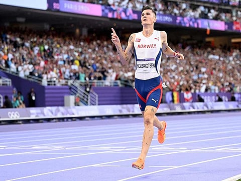 Gold medallist Norway's Jakob Ingebrigtsen celebrates after winning in the men's 5000m final of the athletics event at the Paris 2024 Olympic Games at Stade de France in Saint-Denis, north of Paris, on August 10, 2024.