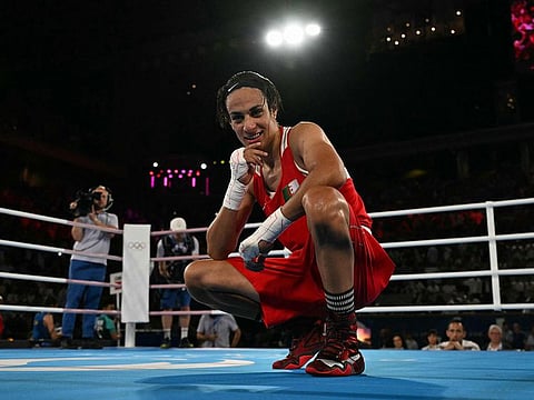 Algeria's Imane Khelif reacts after beating China's Yang Liu (Blue) in the women's 66kg final boxing match during the Paris 2024 Olympic Games at the Roland-Garros Stadium, in Paris on August 9, 2024.