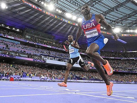 US' Rai Benjamin crosses the finish line ahead of Botswana's Letsile Tebogo in the men's 4x400m relay final of the athletics event at the Paris 2024 Olympic Games at Stade de France in Saint-Denis, north of Paris, on August 10, 2024.