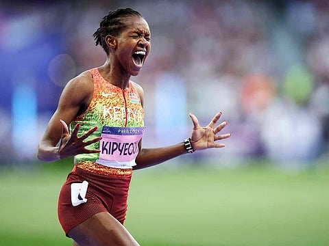 Gold medallist Kenya's Faith Kipyegon reacts as she crosses the finish line in the women's 1500m final of the athletics event at the Paris 2024 Olympic Games at Stade de France in Saint-Denis, north of Paris, on August 10, 2024.