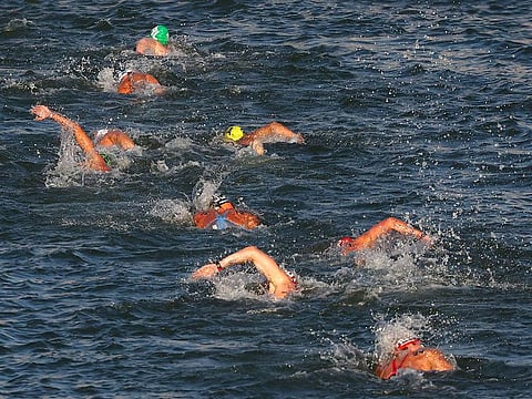 Athletes swim in the Seine river during the men's 10km marathon swimming final at the Paris 2024 Olympic Games at Pont Alexandre III in Paris on August 9, 2024.