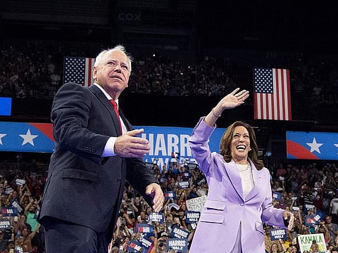 US Vice President and Democratic presidential candidate Kamala Harris (R) and Minnesota Governor and vice presidential candidate Tim Walz gesture during a campaign rally at the Thomas and Mack Center, University of Nevada in Las Vegas, Nevada, on August 10, 2024.