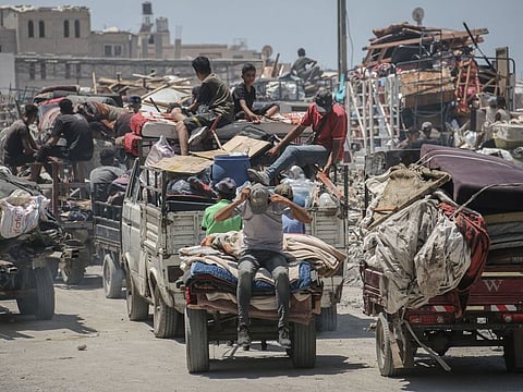Displaced Palestinians flee following evacuation orders from the Israeli army to leave the Hamad district of Khan Younis, southern Gaza, on August 11, 2024.