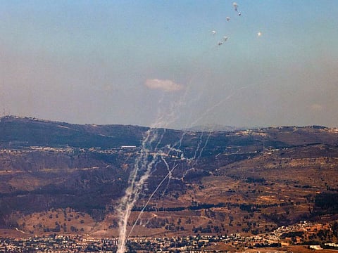 Rockets fired from southern Lebanon are intercepted by Israel's Iron Dome air defence system over the Upper Galilee region in northern Israel on August 9, 2024, amid ongoing cross-border clashes between Israeli troops and Hezbollah fighters.
