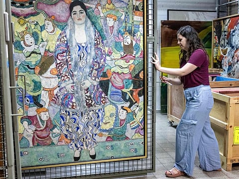 Nathalie Andrijasevic, an assistant curator at the Tel Aviv Museum of Art, handles a painting by Austrian painter Gustav Klimt which was moved to an underground safe room at the museum in Tel Aviv on August 13, 2024.