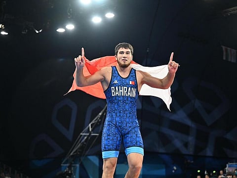 Bahrain's Akhmed Tajzhudinov celebrates after winning the Paris 2024 Olympics gold in the 97kg category.