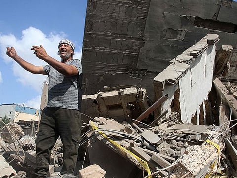 A man inspects the damage to a building after an Israeli strike in the southern town of Kfour, in the Nabatiyeh district, on August 17, 2024, amid the ongoing cross-border clashes between Israeli troops and Hezbollah fighters.