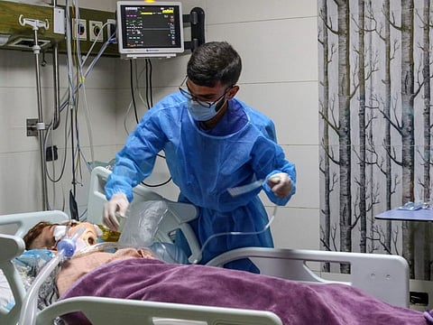 A medic provides medical care to a man injured in an Israeli strike in the Wadi Al Kafur area of the southern Lebanese Nabatiyeh district on August 17, 2024.