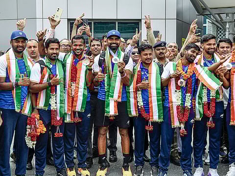 India's Bronze medal-winning Men's Hockey team's coach Shivendra Singh along with Olympic bronze medalists' hockey players PR Sreejesh, Amit Rohidas, Sumit Walmiki, Abhishek Nain and Sanjay Rana pose for a picture on their arrival at IGI airport, in New Delhi on Tuesday.