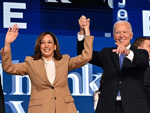 US President Joe Biden holds US Vice President and 2024 Democratic presidential candidate Kamala Harris hand after delivering the keynote address on the first day of the Democratic National Convention.