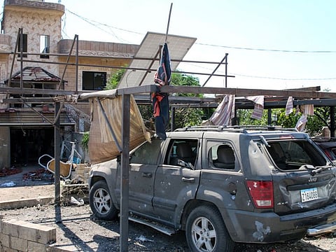 A damaged car is parked outside a building hit by an Israeli strike a day earlier, in the village of Wadi Sheet near the city of Baalbek in eastern Lebanon on August 21, 2024.