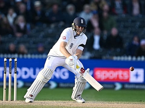 England's Joe Root attempts a scoop shot on day four of the first Test match against Sri Lanka at Old Trafford cricket ground in Manchester, north-west England on August 24, 2024.