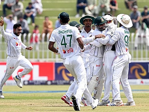 Bangladesh's Mehidy Hasan Miraz (left) celebrates with teammates after taking the wicket of Pakistan's Agha Salman during the fifth and final day of the first Test cricket match at the Rawalpindi Cricket Stadium in Rawalpindi on Sunday.