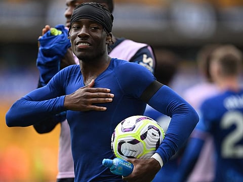 Chelsea's English midfielder Noni Madueke leaves with the match ball having scored a hat-trick during the English Premier League football match against Wolverhampton Wanderers at the Molineux stadium in Wolverhampton, central England on Sunday.