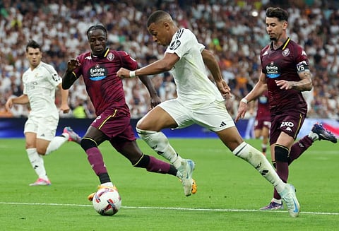 Real Madrid's French forward Kylian Mbappe (2R) is challenged by Real Valladolid's French defender Flavien Boyomo (2L) during the Spanish league football match at the Santiago Bernabeu stadium in Madrid on Sunday.