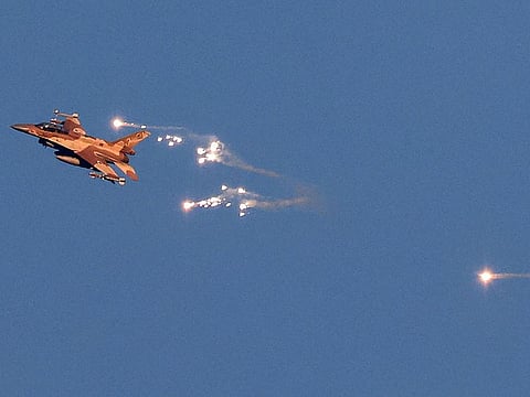This photo taken from a position in northern Israel shows an Israeli Air Force fighter jet firing flares as it flies to intercept a hostile aircraft that launched from Lebanon over the border area with south Lebanon on August 25, 2024.