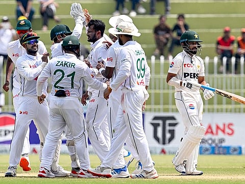 Bangladesh's Shakib Al Hasan (3R) celebrates with teammates after taking the wicket of Pakistan's Saud Shakeel (R) during the fifth and final day of the first Test cricket match between Pakistan and Bangladesh at the Rawalpindi Cricket Stadium in Rawalpindi on August 25, 2024.