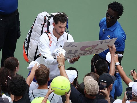 Dominic Thiem of Austria signs his autograph for fans after being defeated by Ben Shelton of the United States in their Men's Singles first round match on Day One of the 2024 US Open at the USTA Billie Jean King National Tennis Center on Monday.