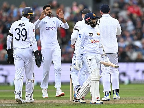 Sri Lanka's captain Dhananjaya de Silva walks back to the pavilion after losing his wicket during the first Test cricket match against England at Old Trafford cricket ground in Manchester on August 21.