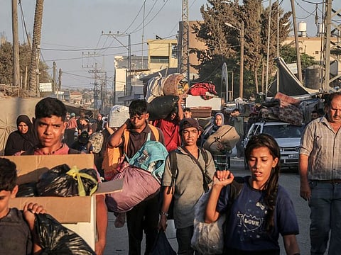 Displaced Palestinians flee a neighborhood after evacuation orders from the Israeli army in Deir al-Balah, central Gaza