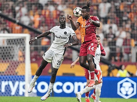 Galatasaray’s forward #44 Michy Batshuayi (CR) and Young Boys' midfielfer #20 Cheikh Niasse (CL) fight for the ball during the Champions League second leg play off football match at the Rams Park stadium in Istanbul, on August 27, 2024.