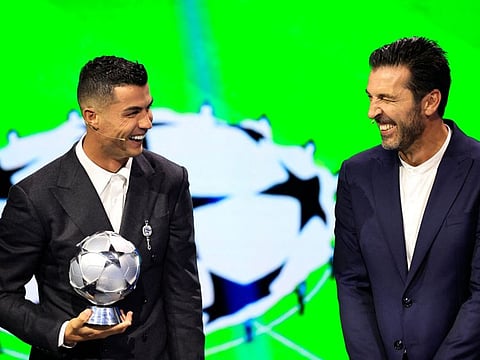 Portugal's national team player and Saudi Al Nassr's forward Cristiano Ronaldo who is awarded the All-Time Goalscorer Award in the Uefa Champions League and Italy's former goalkeeper Gianluigi Buffon who awarded the 2024 Uefa President's Award share a laugh on stage during the ceremony of the draw for the group stage of the 2024-2025 Uefa Champions League football tournament, at the Grimaldi Forum in Monaco on Thursday.