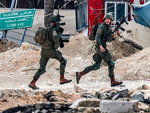 Israeli soldiers take position during an army operation in Tulkarm in the north of the occupied West Bank on August 29, 2024. Israel on August 28 launched a large-scale operation in the occupied West Bank where the military said it killed Palestinian fighters, as the nearly 11-month-old Gaza war showed no signs of abating.