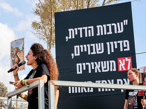 Yarden Gonen, sister of Israeli hostage Romi Gonen (pictured), shouts on a microphone near Kibbutz Nirim in southern Israel by the border with with Gaza on August 29, 2024.
