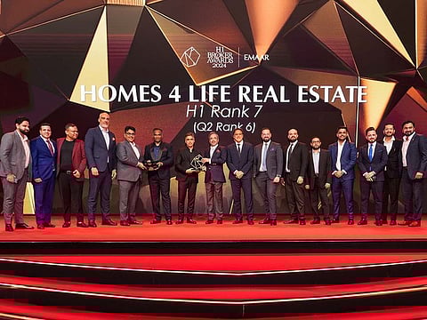 Team Homes 4 Life Real Estate receiving the award from Amit Jain and Santosh P. B. from EMAAR
