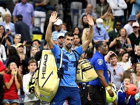 Serbia's Novak Djokovic waves at the crowd after his defeat against Australia's Alexei Popyrin during their men's singles third round match on day five of the US Open tennis tournament at the USTA Billie Jean King National Tennis Center in New York City, on August 30, 2024.
