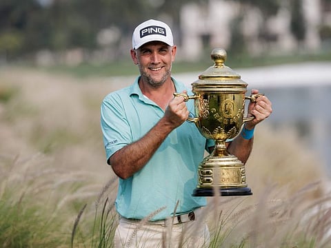 England's Steve Lewton poses with the trophy after winning a play-off during the final round of the Mandiri Indonesia Open golf tournament at the Damai Indah Golf - PIK Course in Jakarta on Sunday.