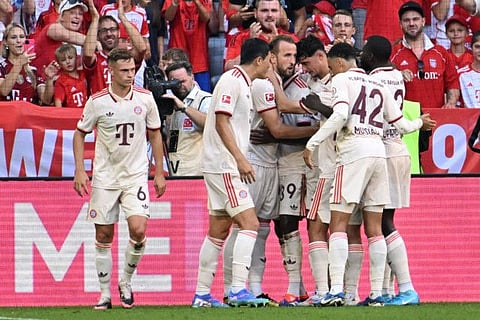 Bayern Munich's English forward Harry Kane celebrates with his teammates during the Bundesliga football match against SC Freiburg in Munich on Sunday.