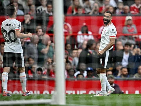Liverpool's Egyptian striker Mohamed Salah (right) celebrates with striker Diogo Jota after scoring the team's third goal during the English Premier League football match against Manchester United at Old Trafford in Manchester on Sunday.