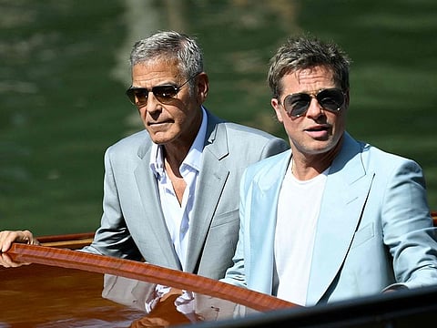 Actors Brad Pitt (L) and George Clooney arrive at the Excelsior pier during the 81st Venice International Film Festival at Venice Lido, on September 1, 2024