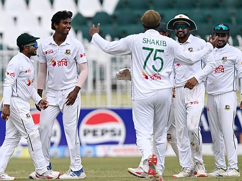 Bangladesh's Hasan Mahmud (2L) celebrates with teammates after taking the wicket of Pakistan's Mohammad Ali during the fourth day of the second and last Test cricket match at the Rawalpindi Cricket Stadium in Rawalpindi on Monday.