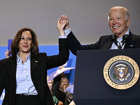 US President Joe Biden (R) holds up US Vice President and Democratic presidential candidate Kamala Harris's hand during a campaign rally at the International Brotherhood of Electrical Workers (IBEW) Local 5 in Pittsburgh, Pennsylvania, on September 2, 2024. (