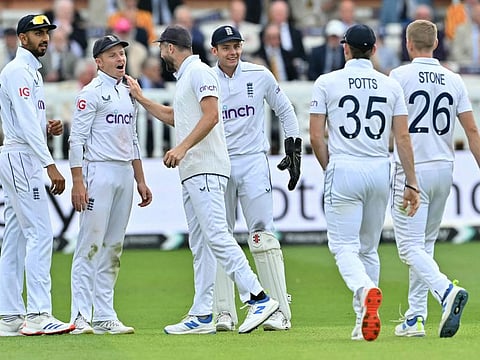 England's Chris Woakes (3L), congratulates England's Ollie Pope after running out Sri Lanka's Lahiru Kumara on day two of the second cricket test match at Lord's cricket ground in London on August 30.