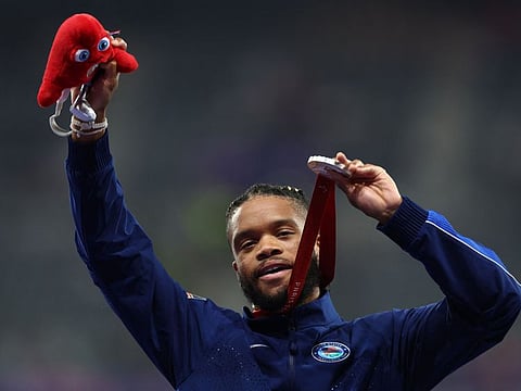 Silver Medallist US' Noah Malone celebrates on the podium during the medal ceremony for the Men's 100m T12 atheletics Final at the Paris 2024 Paralympic Games in the Stade de France, Saint-Denis, north of Paris on August 31.