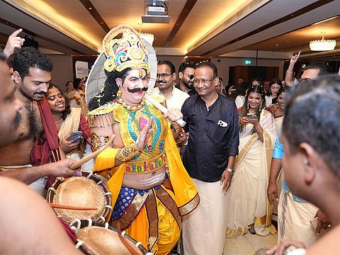 Dressed as Kerala’s mythical King Mahabali or Maveli, Egyptian expat Monzer Nawar greets his colleagues and senior executives, including Dr Sathya Menon to his left, during the company’s early Onam celebrations in Dubai.