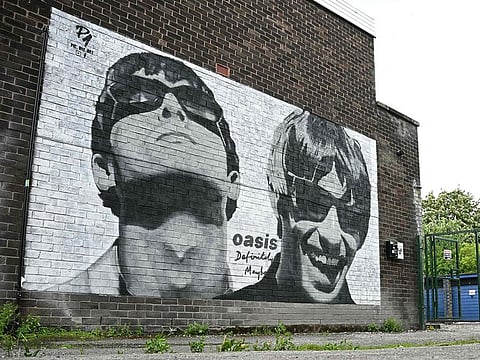 A new street artwork depicting Oasis' Liam and Noel Gallagher, created by Manchester-based street artist Pic.One.Art. is pictured on the side of the Sifters Record store in Burnage, a suburb of Manchester, northern England.